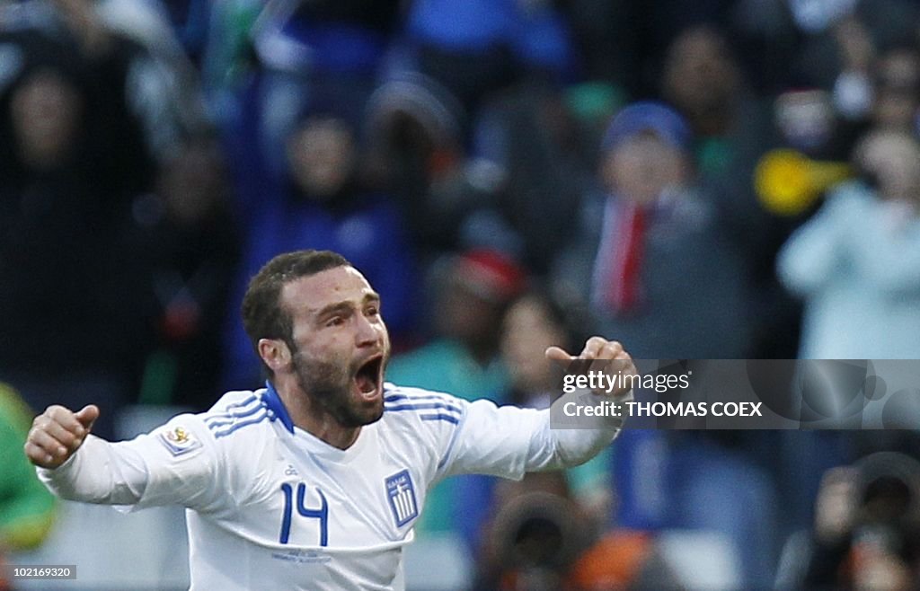 Greece's striker Dimitris Salpingidis celebrates after scoring... News