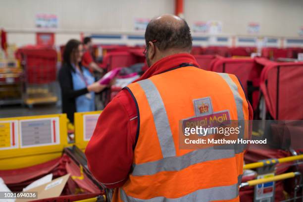 Worker sorts mail at the Royal Mail sorting office on Penarth Road on May 15, 2017 in Cardiff, United Kingdom.