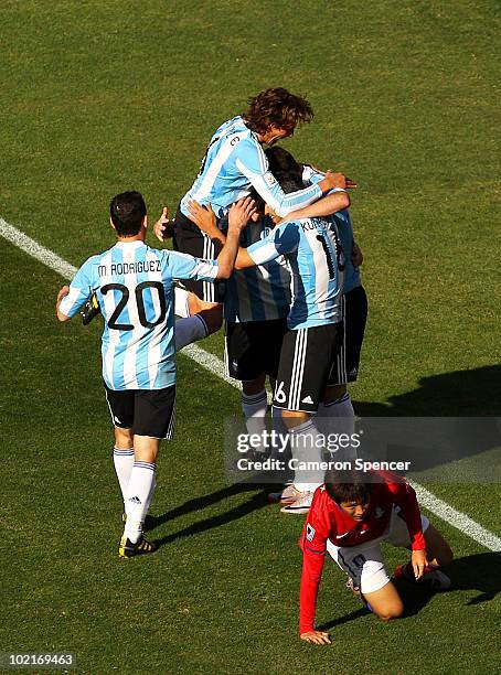 Gabriel Heinze, Sergio Aguero and Maxi Rodriguez of Argentina celebrate a goal by Gonzalo Higuain during the 2010 FIFA World Cup South Africa Group B...