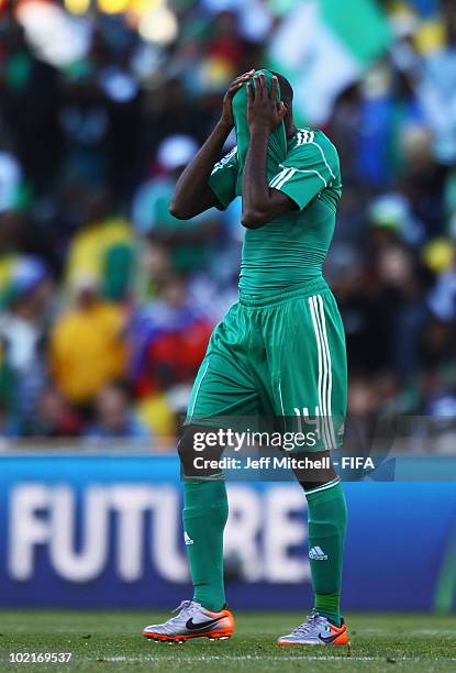 Sani Kaita of Nigeria covers his face as he walks off the pitch after being shown a red card during the 2010 FIFA World Cup South Africa Group B...