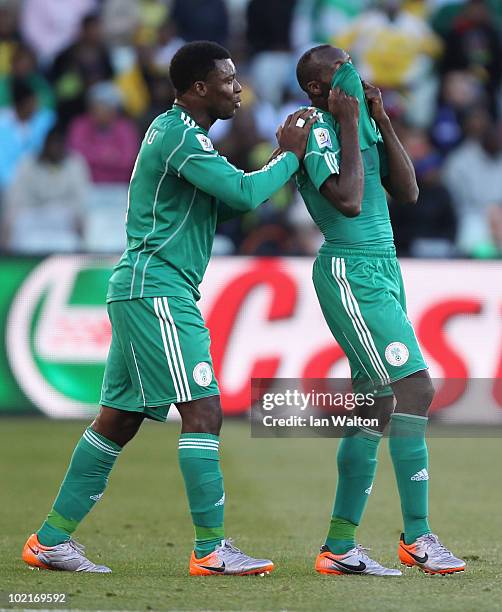 Yakubu Ayegbeni of Nigeria consoles team mate Sani Kaita as he walks off the pitch after being shown a red card during the 2010 FIFA World Cup South...