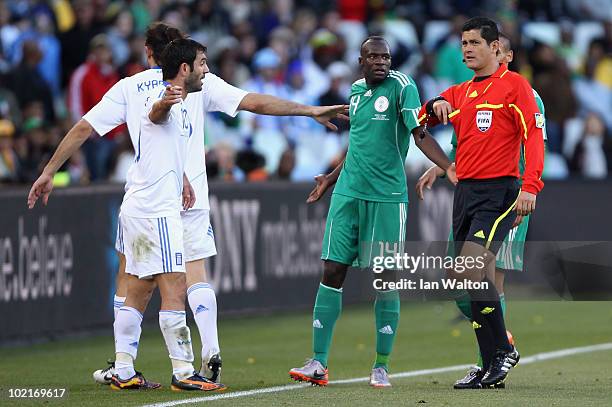 Referee Oscar Ruiz officiates on a challenge by Sani Kaita of Nigeria, which resulted in a red card during the 2010 FIFA World Cup South Africa Group...