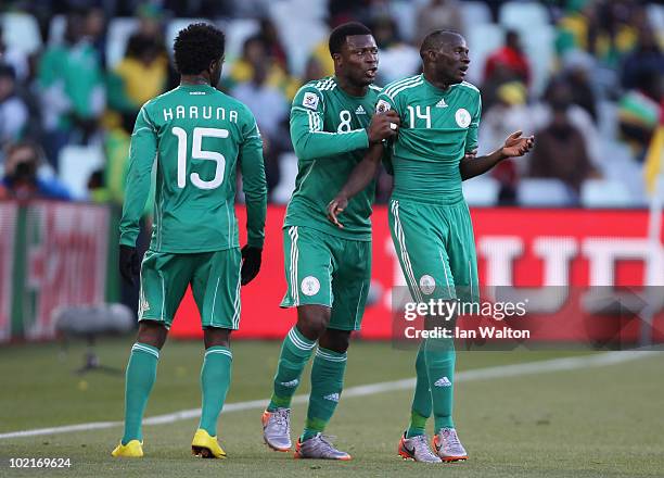 Lukman Haruna and Yakubu Ayegbeni of Nigeria speak to team mate Sani Kaita as he walks off the pitch after being shown a red card during the 2010...