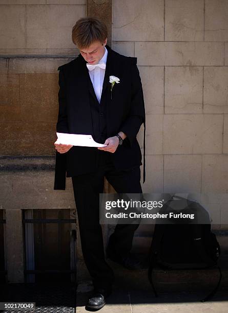 An Oxford University student takes in some last minute revision before entering the Exam Schools building to take examinations on June 17, 2010 in...