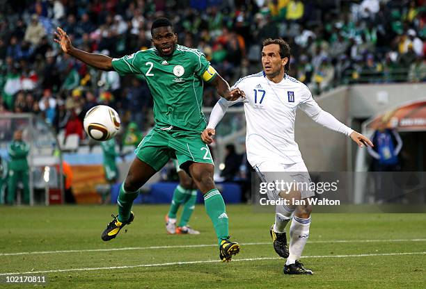 Joseph Yobo of Nigeria and Theofanis Gekas of Greece battle for the ball during the 2010 FIFA World Cup South Africa Group B match between Greece and...