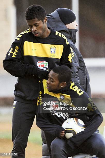 Brazil's soccer player Michel Bastos pushes teammate Robinho to leave the pitch after a training session at Randburg High School, June 17, 2010 in...