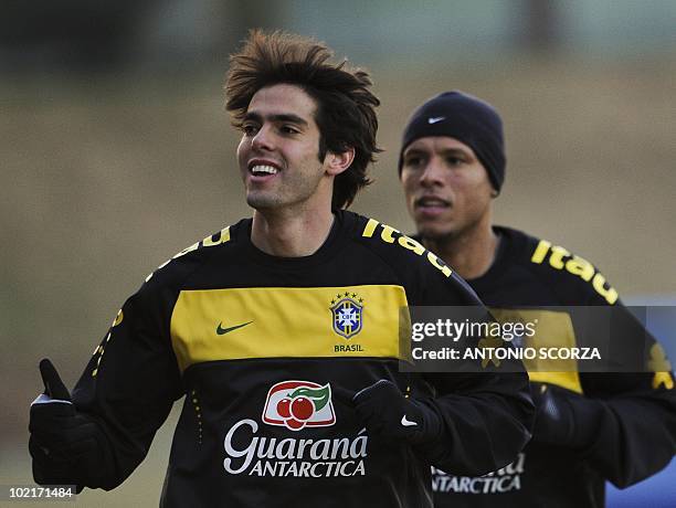 Brazil's striker Kaka gives the thumb up as runs beside teammate Luis Fabiano during a training session at Randburg High School, June 17, 2010 in...