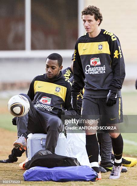 Brazil's striker Robinho controls the ball observed by Elano during a training session at Randburg High School, June 17, 2010 in Johannesburg. Brazil...