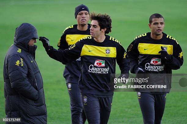 Brazil's midfielder Kaka plays with an team member next to teammates striker Luis Fabiano and midfielder Felipe Melo during a training session at the...