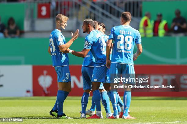 Joelinton of Hoffenheim celebrates the first goal for Hoffenheim with teammate Alexander Stolz of Hoffenheim during the first round DFB Cup match...