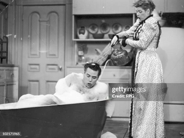 American comedienne and actress Lucille Ball with her co-star and husband Desi Arnaz in a scene from the American television sitcom 'I Love Lucy',...