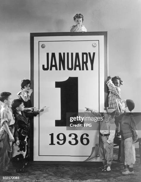 American child actors of the Hal Roach 'Our Gang' and 'Little Rascals' comedy films, with an outsize calendar for 1st January 1936.