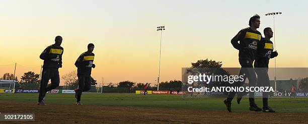 Brazil's striker Kaka runs beside teammate midfielder Felipe Melo during the practices at Randburg High School, June 17, 2010 in Johannesburg. Brazil...