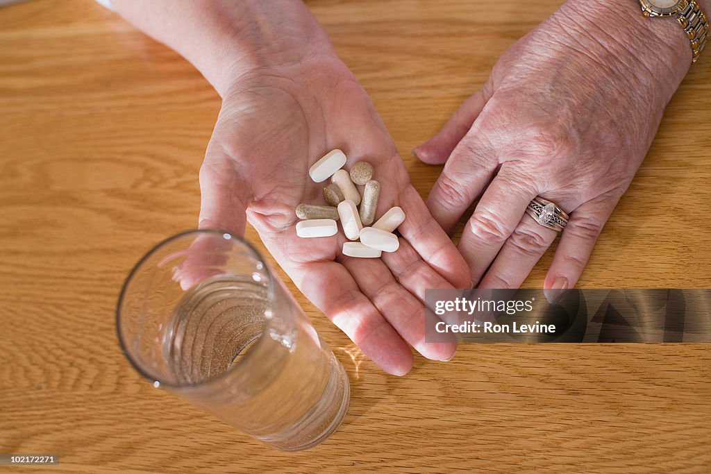 Senior woman's hand filled with pills