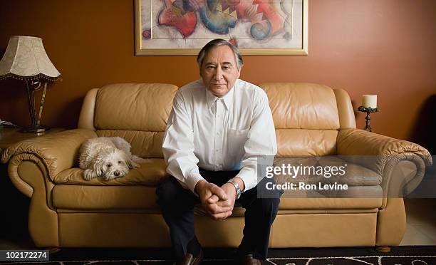 mature man on sofa with his pet dog - sitting on couch imagens e fotografias de stock