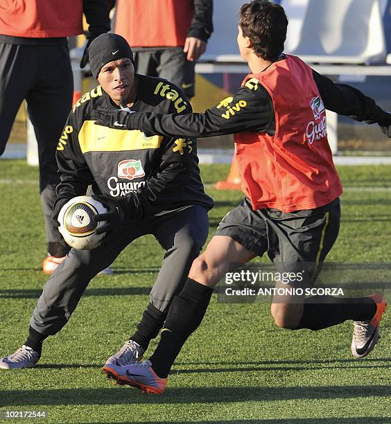 Brazil' soccer players Luis Fabiano and Nilmar fights for the ball during a training session at Randburg High School, June 17, 2010 in Johannesburg....