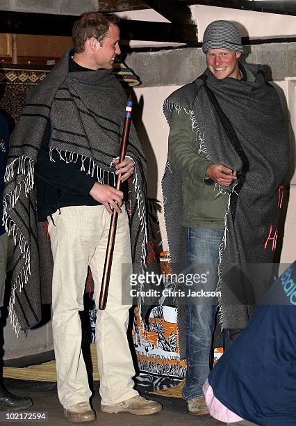 Prince Harry and Prince William smile as they stand on stage at St Leonard's Herd Boy School on June 16, 2010 in Semonkong, Lesotho. The two Princes...