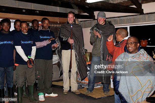 Prince Harry and Prince William smile as they stand on stage at St Leonard's Herd Boy School on June 16, 2010 in Semonkong, Lesotho. The two Princes...