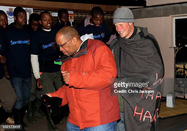 Prince Harry and Prince Seeiso dance on stage at St Leonard's Herd Boy School on June 16, 2010 in Semonkong, Lesotho. The two Princes are on a joint...
