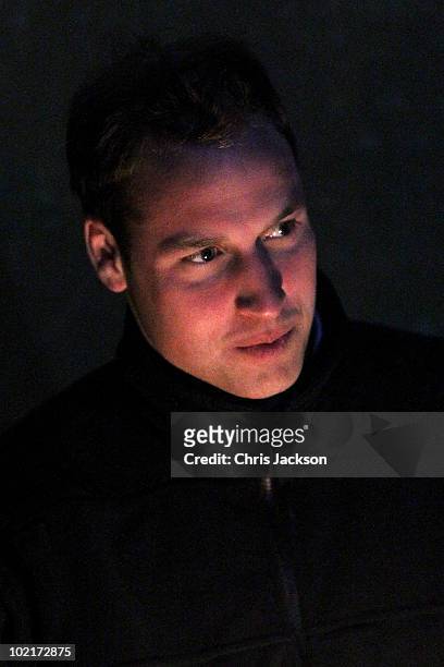Prince William looks on in the faint candlelight as he visits Semonkong Herd Boy School on June 16, 2010 in Semonkong, Lesotho. The two Princes are...