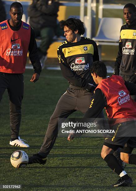 Brazil's players Kaka controls the ball observed by teammates Grafite and Josue during a training session Randburg High School on June 17, 2010 in...