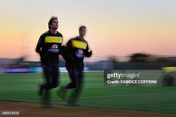 Brazil's midfielder Kaka runs with teammate midfielder Felipe Melo during a training session at the Randburg High School on June 17, 2010 in...