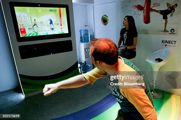 An attendee tries the Your Shape: Fitness game using the Kinect device on Microsoft Corp.'s Xbox 360 gaming console during the Electronic...