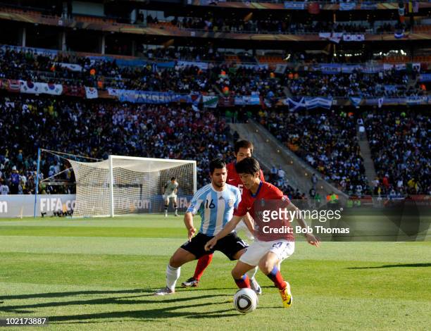 Sergio Aguero of Argentina watches Lee Chung-Yong of South Korea during the 2010 FIFA World Cup South Africa Group B match between Argentina and...