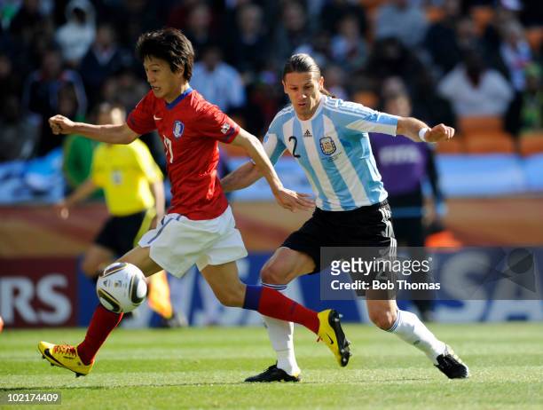 Lee Chung-Yong of South Korea fights for the ball with Martin Demichelis of Argentina during the 2010 FIFA World Cup South Africa Group B match...