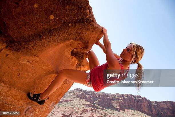 woman climbing rock - woman climb bildbanksfoton och bilder