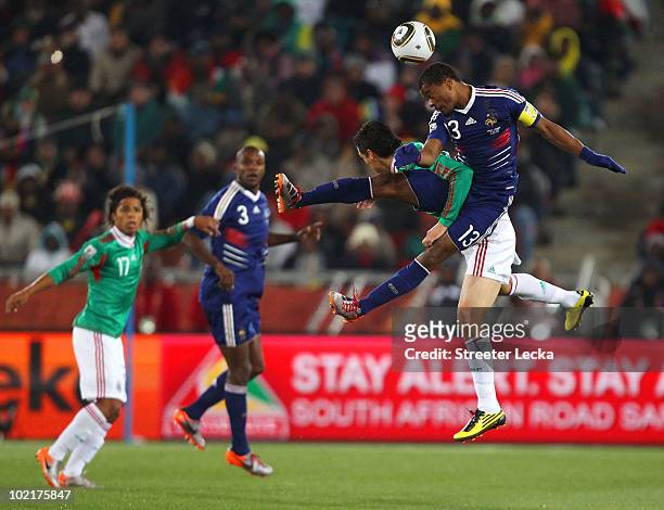 Patrice Evra of France wins the header under pressure from Guillermo Franco of Mexico during the 2010 FIFA World Cup South Africa Group A match...