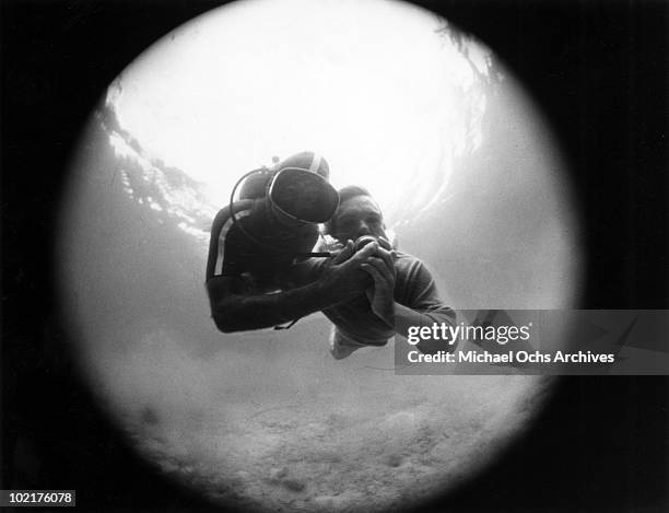 Alejandro Zayas and Chirstofer Perdeger scuba dive in a scene from the movie "Black Water Gold"which was released in January 6, 1970.