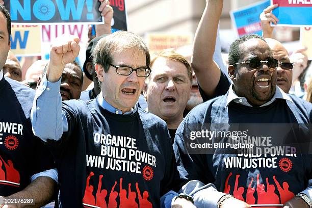 Newly-elected United Auto Workers president Bob King and Teamsters President James Hoffa march through downtown Detroit after the closing of the 2010...