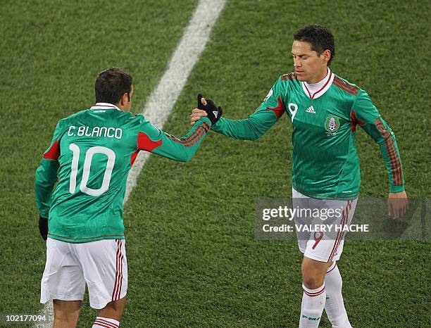 Mexico's striker Guillermo Franco shakes hands with Mexico's striker Cuauhtemoc Blanco during their Group A first round 2010 World Cup football match...
