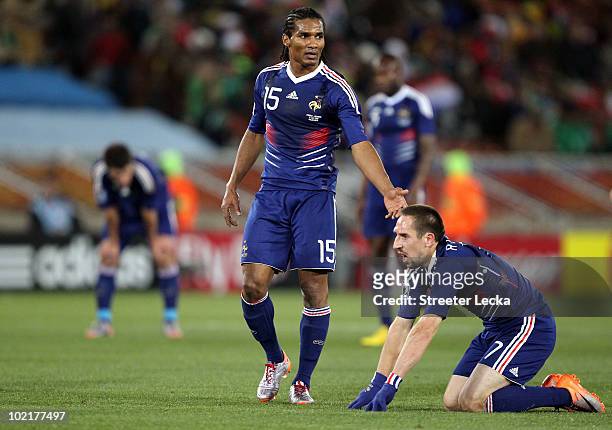 Florent Malouda of France helps up team mate Franck Ribery during the 2010 FIFA World Cup South Africa Group A match between France and Mexico at the...