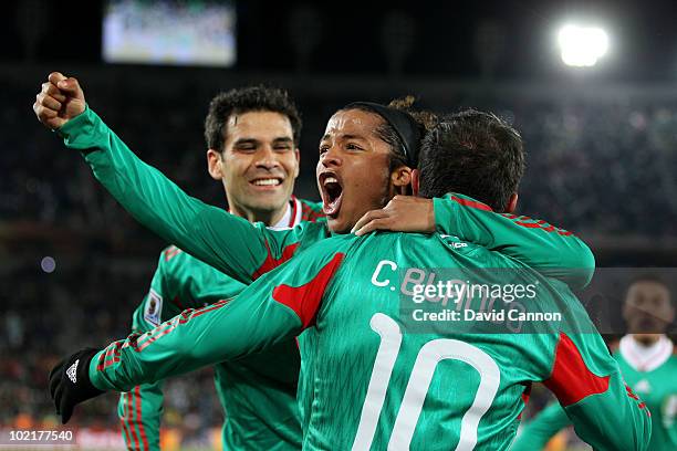 Giovani Dos Santos of Mexico celebrates with Cuauhtemoc Blanco after he scored a penalty for his team's second goal during the 2010 FIFA World Cup...