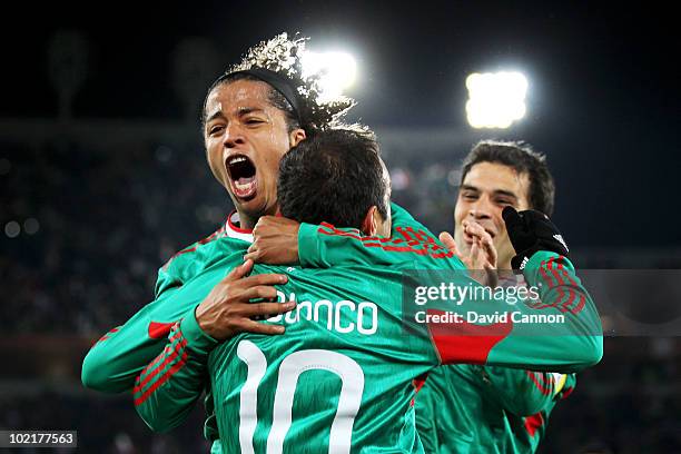 Giovani Dos Santos of Mexico celebrates with Cuauhtemoc Blanco after he scored a penalty for his team's second goal during the 2010 FIFA World Cup...