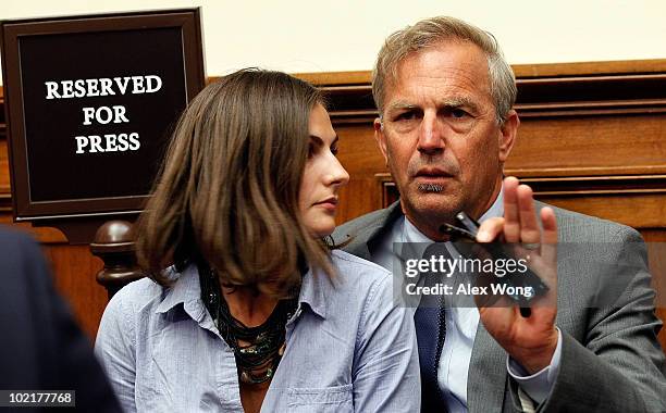 Actor Kevin Costner sits with his daughter Annie Costner while listening to BP Chief Executive Tony Hayward testify before the Oversight and...