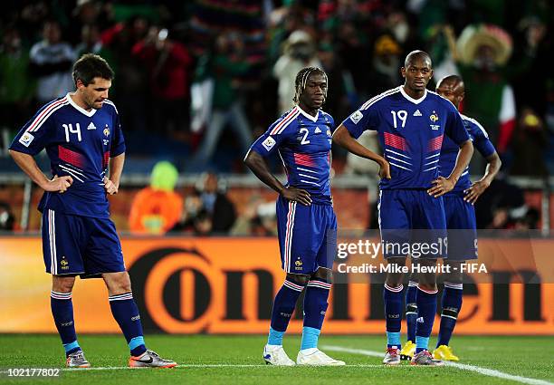 Jeremy Toulalan, Bakari Sagna and Abou Diaby of France looks dejected during the 2010 FIFA World Cup South Africa Group A match between France and...