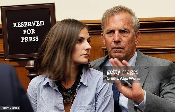 Actor Kevin Costner sits with his daughter Annie Costner while listening to BP Chief Executive Tony Hayward testify before the Oversight and...