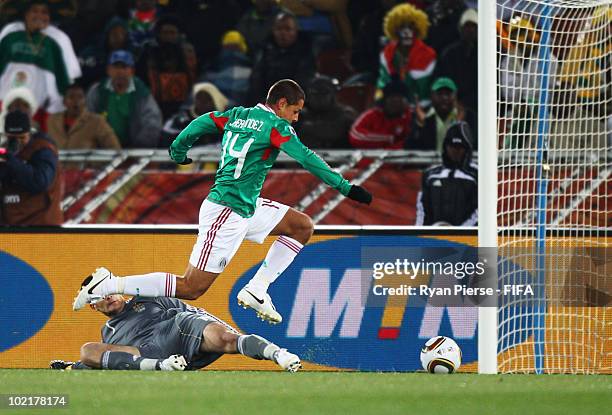 Javier Hernandez of Mexico scores the opening goal against goalkeeper Hugo Lloris of France during the 2010 FIFA World Cup South Africa Group A match...