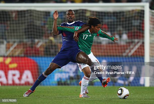 Giovani Dos Santos of Mexico is challenged by Eric Abidal of France during the 2010 FIFA World Cup South Africa Group A match between France and...