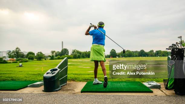 The active, optimistic 77-years-old senior Black woman playing golf