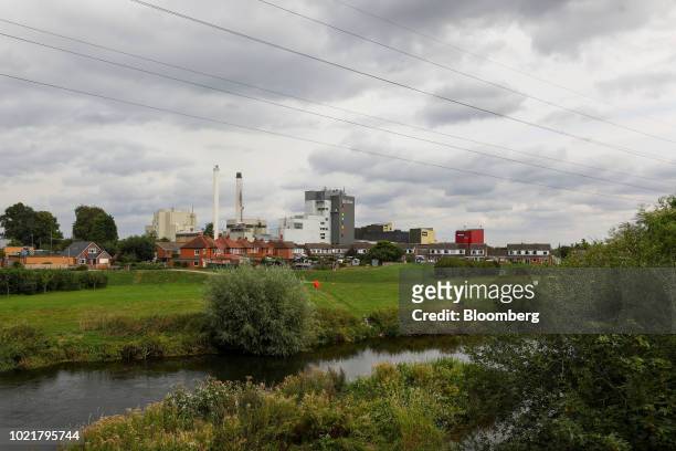 Fisherman fishes on the banks of the River Dove in view of the Nescafe factory, operated by Nestle SA, in Tutbury, U.K., on Thursday, Aug. 23, 2018....