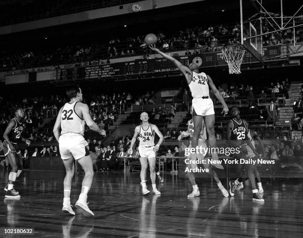 Tom Stith of the St. Bonaventure Bonnies goes up for a rebound against the St. John's Redmen during a game in the ECAC Holiday Tournament at Madison...
