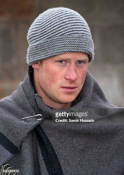 Prince Harry wears a warm hat and blanket when he visits the Herd Boy School on June 17, 2010 in Semonkong, Lesotho. The Princes are on a joint trip...