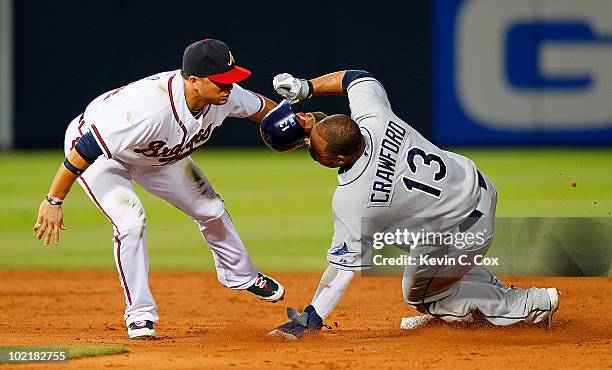 Martin Prado of the Atlanta Braves tags out a sliding Carl Crawford of the Tampa Bay Rays at second base at Turner Field on June 17, 2010 in Atlanta,...