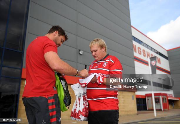 Danny Cipriani of Gloucester Rugby signs an autograph for a fan prior to the start during the Pre Season Friendly match between Gloucester Rugby and...