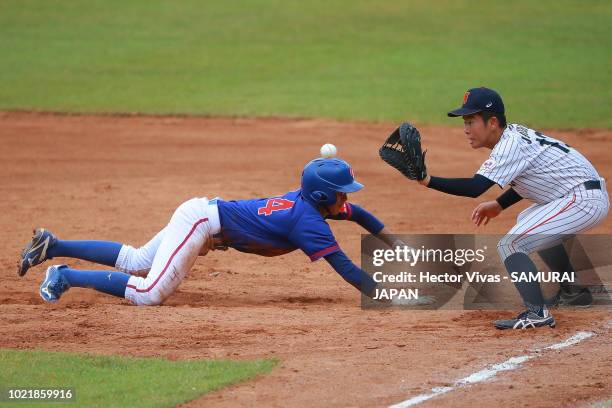 Tung-Sen Li of Chinese Taipei slides safely into first base against Hiromu Joshita of Japan in the 3rd inning during the Bronze Medal match of WSBC...