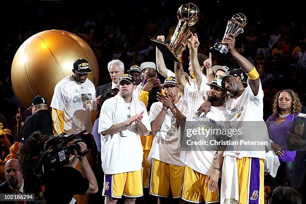 Derek Fisher and Kobe Bryant of the Los Angeles Lakers hold up the Larry O'Brien trophy and the MVP trophy after the Lakers defeated the Boston...